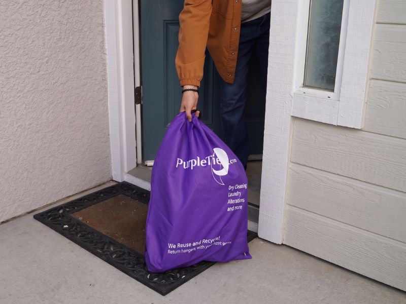 Driver collecting laundry at the doorstep